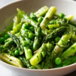 asparagus with peas sautéed in skillet with fresh herbs