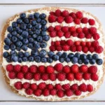 American Flag-Themed Fruit Pizza decorated with blueberries and raspberries