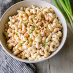 Hawaiian Macaroni Salad served in a bowl with carrots and green onions