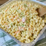 Macaroni Salad for a Crowd served in a large tray with vegetables and creamy dressing