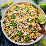 Mexican street corn pasta salad with corn, black beans, jalapeños, cheese, and lime