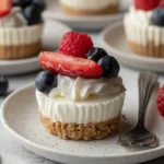 No-Bake Mini Cheesecake Cups topped with strawberries, blueberries, and raspberries