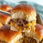Oven-Baked Cheeseburger Sliders with melted cheddar cheese on soft buns