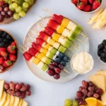 Rainbow fruit skewers with strawberries, pineapple, grapes, blueberries, and kiwi