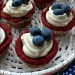 Red white and blue cookie cups topped with cream frosting and fresh blueberries