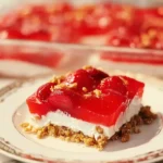 Slice of strawberry pretzel salad with creamy layers and fresh strawberries