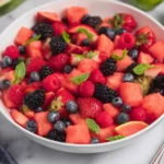 Watermelon fruit salad with strawberries, blueberries, raspberries, and blackberries