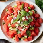 Watermelon mint salad with cucumber, feta cheese, and fresh mint leaves